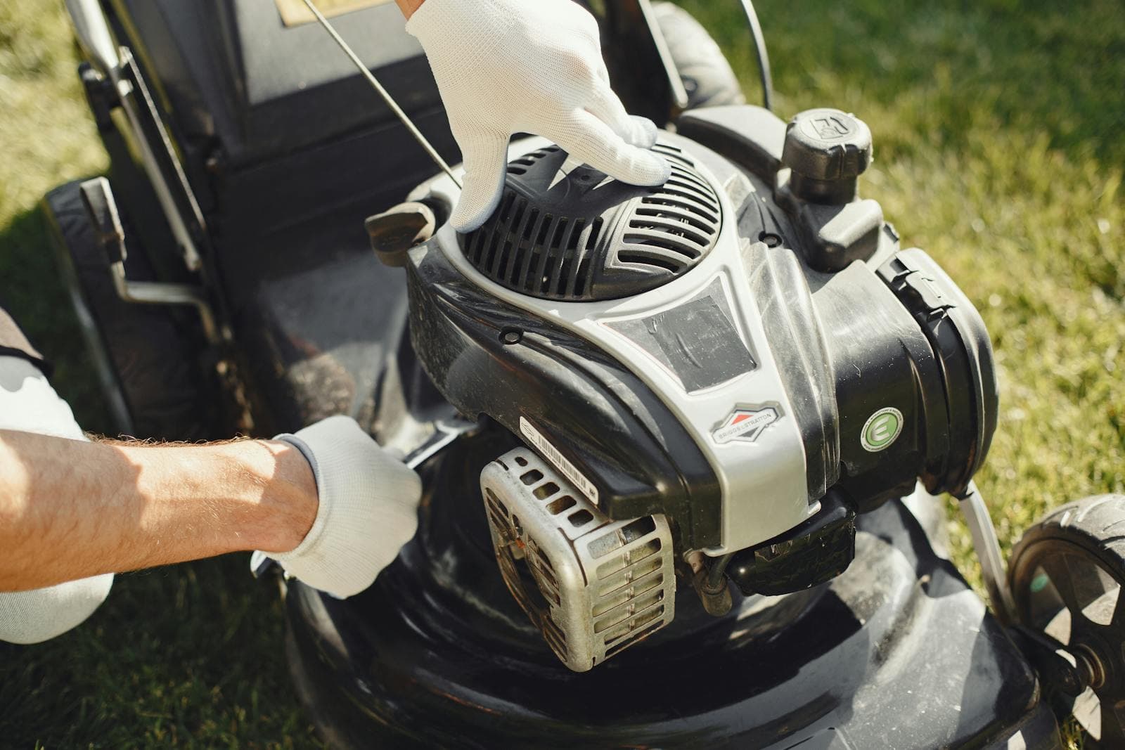 Gardener mowing a lush green Florida lawn